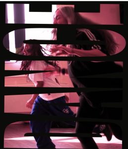 An image created by a black cut out of the word DANCE, vertically, against a purpleish picture of two figures dancing.